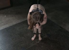 Busty and juicy pale skin girl is shackled on the floor