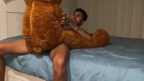 Gay twink takes big cock in his mouth while stuffed with his favorite teddy bear
