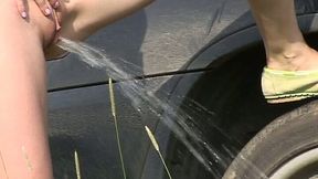 Svelte redhead flashes tits and pisses near the car outdoors