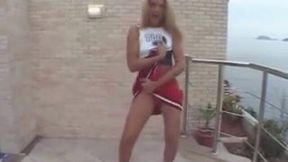 That's my curly shemale friend in cheerleader costume strips and dances