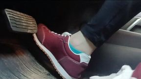 Evalynn driving a loaner truck in red sneakers