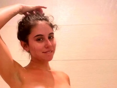 Striking teen with perky boobs pleases herself in the shower