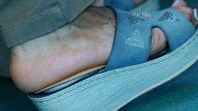 Sandals and foot fetish watching close-up, hot foot heels, the feet move continuously in an attractive way