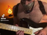 Guy with a ball gag plays guitar
