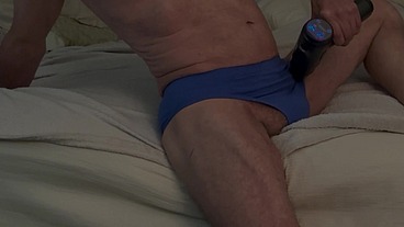 On the Bed with Massage Gun In Blue Briefs for Deep Pelvic Muscle Stimulation Again