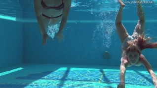 Two tight babes swimming naked together