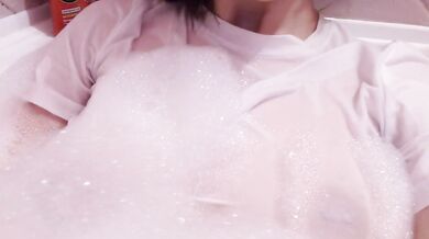 having fun in the bathtub with foam in a wet white top. I smoke and listen to 2rbina2rists