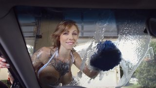 Big breasted lady is washing the car with her large tits