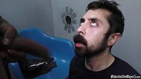 Bearded white man sucking and fucking a black cock at a gloryhole