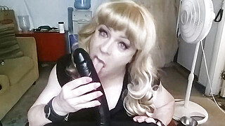 Thick blonde shemale wraps her mouth around a huge black dildo to show her amazing cocksucking skills