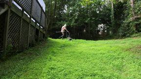 Big Fake Tits Crossdresser in Daisy Dukes Mowing Grass