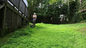 Big Fake Tits Crossdresser in Daisy Dukes Mowing Grass