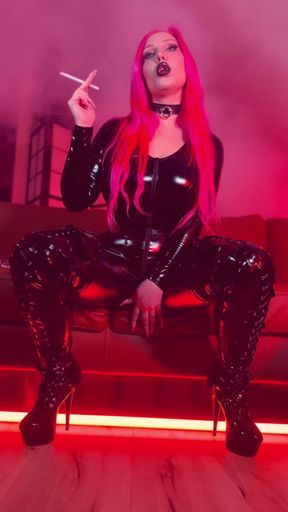 Pink haired Luvie Doll smoking her EVE 120s cigarette like a demon in her pvc catsuit and long fingernails