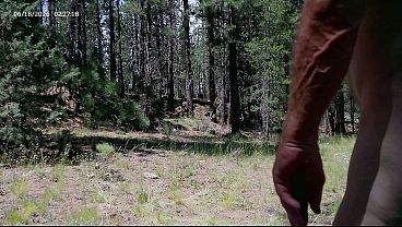 Hairy forest babe flaunts huge cock in homemade naked walk