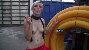 Cute blonde gal smokes cigar outdoor and poses