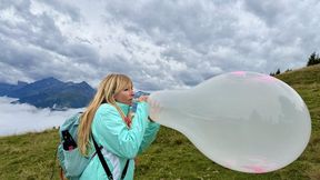 Evil-Lyn blow to pop a Cattex 18 inch Stuffer-Balloon in the Kitzbueheler Alpes