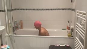 Aquatic Allure: A Swimming Cap Sensation in the Tub