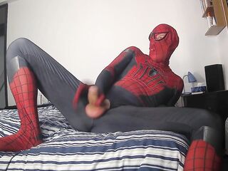 Spiderman jerking off his vertical shlong and cumming with a large spunk fountain spurting cum over himself