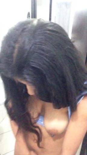 Latina satisfies her pussy in a public bathroom