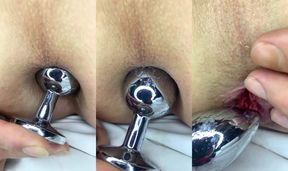Princess plays with a pink metal buttplug.
