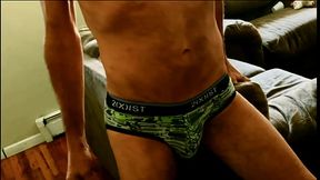 Stretching Groin And Back In Digitial Camo Briefs with Bulge On Couch