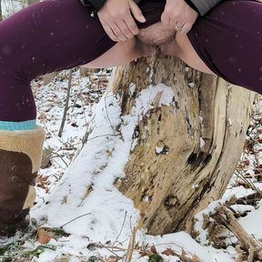 Peeing up against a tree in winter