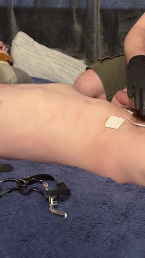 Twink Being Edged with E-stim While Getting His Throat Fingered
