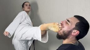 Karateka Aura mercilessly kicks a slave and makes him worship her feet