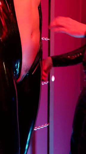 Slave Girl in Latex Catsuit in Electro-shock-heels