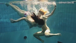 Girls Andrea and Monica stripping one another underwater