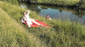 Wild beach. Sexy MILF Platinum naked sunbathing on river bank, random fisherman guy watches. Naked in public. Nude beach