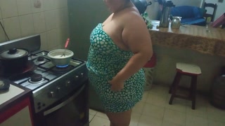 chubby stepmother in the kitchen preparing a delicious dinner