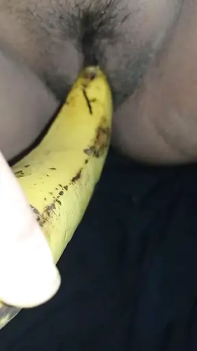 Indian girl playing with banana