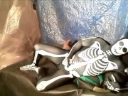 fantasy scene where spandex skeleton wrestles and humps frogman