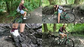 Nastya on a bicycle stuck in deep mud