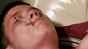 Teen gay Denis lights up cigar and tugs meat with hand