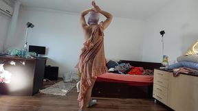 Sexy mom has fun trying on clothes and cutting them.