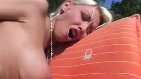 Blonde girl in bikini wanks her big tits and pussy by the pool