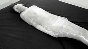 Mummified in plastic wrap girl gets fucked and squirts after fingering