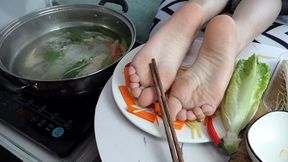 The girl's bare feet on the dinner plate are more attractive with vegetables