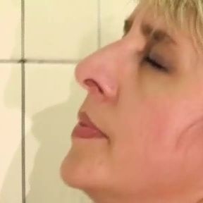 Wild German lady gets pissed and fucked in the bathroom by a long cock