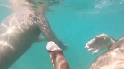 Kinky guys are giving one another an underwater handjob in the sea