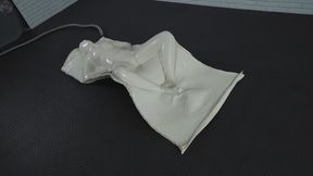 Sonya lies relaxed in a frog position inside a soft white latex vacuum bed