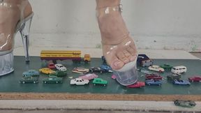 Giantess goddess Charlie Caroline Crushes many tiny cars and trucks in big stripper heels with painted toenails close ground view