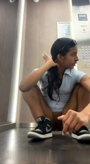 Woman squirts in public elevator while masturbating