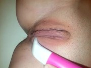 Teen shaves her hairy pussy with an electric razor in the shower.