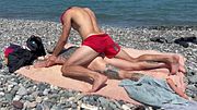 A big-dicked guy fucked a twink on the beach and came several times