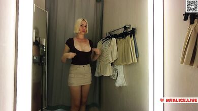 Blonde bombshell flashes puffy nipples in see through bra while trying on clothes