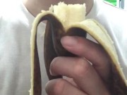 Peel and eat a large, black banana by hand.