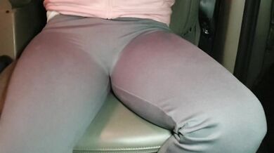 Blonde British girl wets her yoga pants texting in the car grip